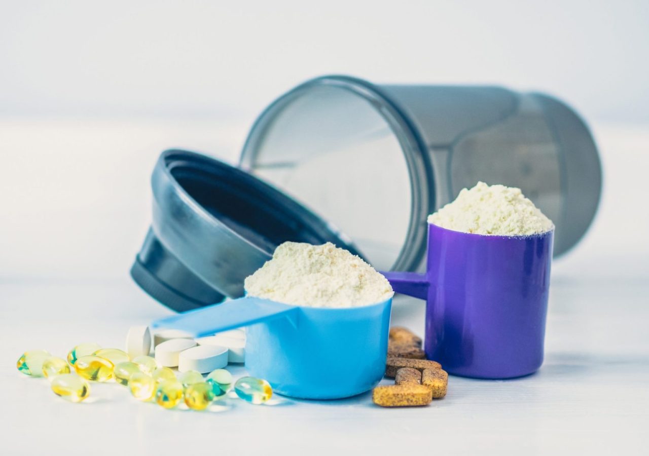 Sport food supplements. Sport Pills, vitamins and protein powder on the white table